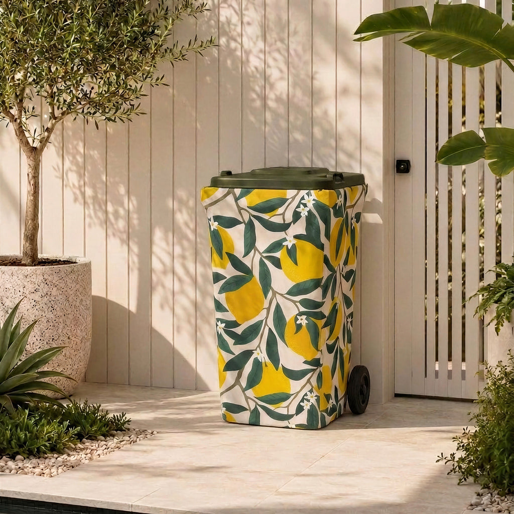Lemon Squeeze wheelie bin cover on a bin in a modern Australian courtyard beside an olive tree