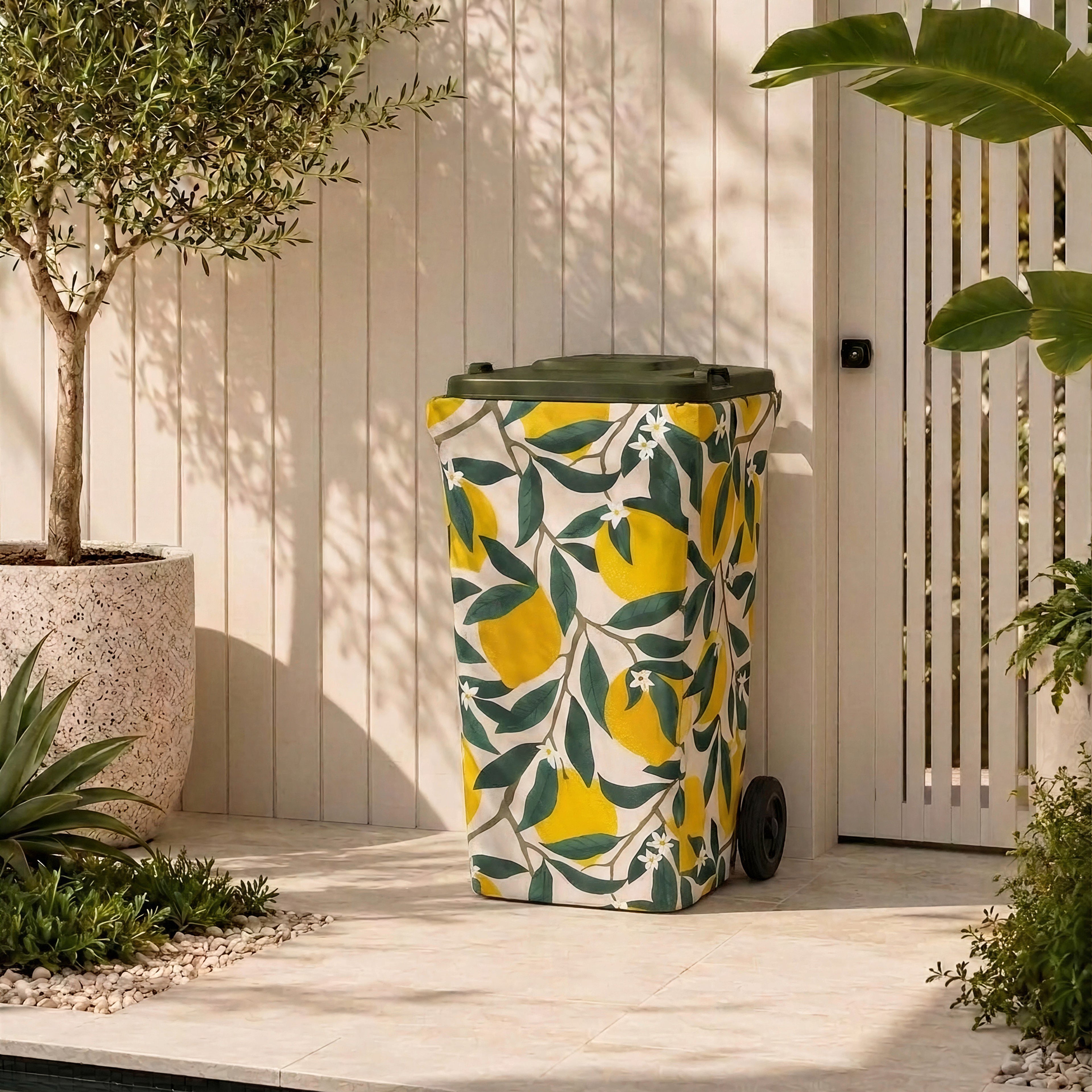 Lemon Squeeze wheelie bin cover on a bin in a modern Australian courtyard beside an olive tree
